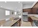 Kitchen with a granite island, stainless steel refrigerator, and modern appliances at 9467 Samuel Clemens Ct, Las Vegas, NV 89147
