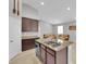 Kitchen with central island sink, dark cabinets, and stainless appliances with an open-concept design at 9467 Samuel Clemens Ct, Las Vegas, NV 89147