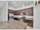 Well-lit kitchen featuring stainless appliances, granite countertops, and dark wood cabinets at 9467 Samuel Clemens Ct, Las Vegas, NV 89147