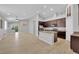 Open-concept living area featuring a modern kitchen, dining space, and light wood floors at 9467 Samuel Clemens Ct, Las Vegas, NV 89147