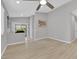 Bright and airy living space with wood-look flooring, neutral walls, and modern ceiling fan at 9467 Samuel Clemens Ct, Las Vegas, NV 89147
