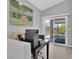 Bright home office with a desk, computer, and sliding glass door to the backyard at 9467 Samuel Clemens Ct, Las Vegas, NV 89147