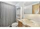 This bathroom includes a vanity sink, toilet, and shower/tub combo, featuring a black and white shower curtain at 960 Third St, Pahrump, NV 89048