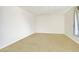 This bedroom has neutral carpet, a window with curtains, and plenty of space at 960 Third St, Pahrump, NV 89048