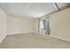 This bedroom has neutral carpet, a window with curtains, and ample natural light at 960 Third St, Pahrump, NV 89048