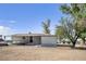 Exterior side view of a single-story home with an unfinished yard at 960 Third St, Pahrump, NV 89048
