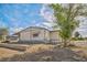 Exterior side view of a single-story home with an unfinished yard at 960 Third St, Pahrump, NV 89048