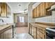 Galley kitchen features white appliances, tile backsplash, wood counters, and view to Gathering room at 960 Third St, Pahrump, NV 89048