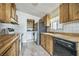 Traditional kitchen features wood cabinets, white appliances, and a view to laundry area at 960 Third St, Pahrump, NV 89048