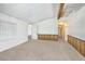Spacious living room features carpeted flooring, beamed ceiling, and wood paneled walls at 960 Third St, Pahrump, NV 89048