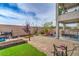 Spacious backyard featuring gravel landscaping, a barbecue area, and mature shade trees at 10031 Fletcher Peak Ave, Las Vegas, NV 89178