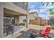 Outdoor living with a patio, swing, fire pit, and lush landscaping creating a serene setting at 10031 Fletcher Peak Ave, Las Vegas, NV 89178