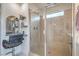 Bathroom with glass enclosed shower, shower seat, and a built-in mirror at 10031 Fletcher Peak Ave, Las Vegas, NV 89178