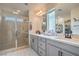 Modern bathroom featuring a glass-enclosed shower, dual sinks, and plenty of counter space at 10031 Fletcher Peak Ave, Las Vegas, NV 89178