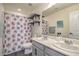 Bathroom with dual sinks, floral shower curtain, and modern fixtures at 10031 Fletcher Peak Ave, Las Vegas, NV 89178