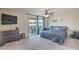 Comfortable bedroom with a private balcony, ceiling fan and ample natural light at 10031 Fletcher Peak Ave, Las Vegas, NV 89178