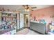 Charming Bedroom showcases a crib, gray dresser, floral closet, and decorative wall art at 10031 Fletcher Peak Ave, Las Vegas, NV 89178