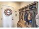 Welcoming entryway with a custom storage bench, wreath, and convenient hanging hooks at 10031 Fletcher Peak Ave, Las Vegas, NV 89178