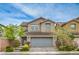 Charming two-story home with a well-manicured lawn and a spacious two car garage at 10031 Fletcher Peak Ave, Las Vegas, NV 89178