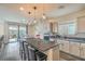 Modern kitchen featuring an island with seating, stainless steel appliances, and stylish pendant lighting at 10031 Fletcher Peak Ave, Las Vegas, NV 89178