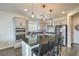 Modern kitchen featuring an island with seating, stainless steel appliances, and stylish pendant lighting at 10031 Fletcher Peak Ave, Las Vegas, NV 89178