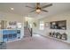 Inviting living area with ceiling fan, TV, and staircase, creating a welcoming atmosphere at 10031 Fletcher Peak Ave, Las Vegas, NV 89178