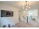 Upstairs loft area with TV, modern lighting, and iron railing at 10031 Fletcher Peak Ave, Las Vegas, NV 89178