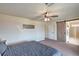 Spacious main bedroom featuring a ceiling fan, a barn door to the bathroom, and carpeted floors at 10031 Fletcher Peak Ave, Las Vegas, NV 89178