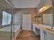 Bright bathroom featuring a soaking tub, double sinks, walk in shower, and neutral walls at 10279 Montes Vascos Dr, Las Vegas, NV 89178