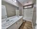 Bathroom with a large vanity with dual sinks and a shower over tub at 10279 Montes Vascos Dr, Las Vegas, NV 89178