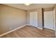 Neutral bedroom with new flooring and a closet that complements the walls and trim at 10279 Montes Vascos Dr, Las Vegas, NV 89178