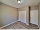Cozy bedroom featuring closet and door, with hard wood floors, and neutral color scheme at 10279 Montes Vascos Dr, Las Vegas, NV 89178