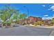 The community is well landscaped with a decorative wall, bushes and several trees at 10279 Montes Vascos Dr, Las Vegas, NV 89178