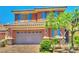 Charming two-story home featuring a tile roof, blue shutters, and a well-maintained front yard at 10279 Montes Vascos Dr, Las Vegas, NV 89178
