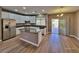 Bright kitchen with white cabinetry, stainless appliances, and island with granite countertops at 10279 Montes Vascos Dr, Las Vegas, NV 89178