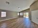 Living room featuring high ceilings, wood floors and doors to the outdoor patio at 10279 Montes Vascos Dr, Las Vegas, NV 89178