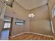Open-concept living room with hardwood floors, high ceilings and chandelier at 10279 Montes Vascos Dr, Las Vegas, NV 89178