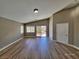 Bright living room with hardwood floors, high ceilings, and sliding glass doors to the outdoor space at 10279 Montes Vascos Dr, Las Vegas, NV 89178