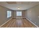Spacious living room with built-in shelves, hardwood floors, and natural light from two windows at 10279 Montes Vascos Dr, Las Vegas, NV 89178