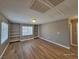 Bright living room featuring built-in shelves, wood floors, and natural light from the windows at 10279 Montes Vascos Dr, Las Vegas, NV 89178