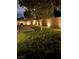 This backyard has grass, trees, brick walls and outdoor lighting at 1038 Beaver Crest Ter, Henderson, NV 89015