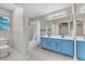 Well-lit bathroom featuring double sinks, large mirrors, and a shower-tub combo at 1038 Beaver Crest Ter, Henderson, NV 89015
