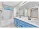 Bathroom with double sink vanity, bathtub with shower, and large mirror at 1038 Beaver Crest Ter, Henderson, NV 89015