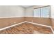 This bedroom features wood floors, neutral walls, and a window that provides natural light at 1038 Beaver Crest Ter, Henderson, NV 89015
