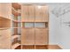 Walk-in closet with custom built-in shelving and drawers for organized storage at 1038 Beaver Crest Ter, Henderson, NV 89015