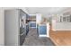 Open concept kitchen with stainless steel appliances, blue cabinetry, and an island bar at 1038 Beaver Crest Ter, Henderson, NV 89015