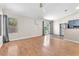 Bright living room with wood floors, ceiling fan, and sliding glass door to the backyard at 1038 Beaver Crest Ter, Henderson, NV 89015