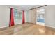 Bedroom featuring light wood floors, a sliding barn door, and bright red curtains at 1038 Beaver Crest Ter, Henderson, NV 89015