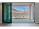 Sliding glass door to a backyard with desert landscaping and mountain views at 11173 Concord Valley Dr, Las Vegas, NV 89135