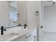 This bathroom features dual vanity sinks with black hardware and a large mirror at 11173 Concord Valley Dr, Las Vegas, NV 89135
